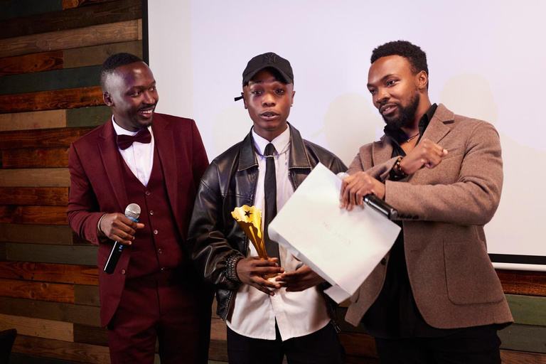 An award being presented on stage at the AKZAM Awards