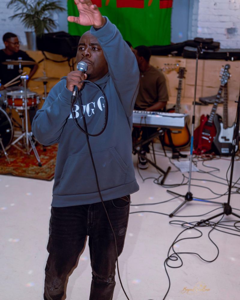 Boz Zambia performing live with a microphone
