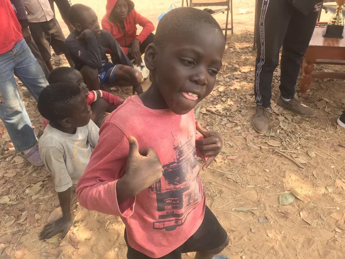 A smiling child at an AKZAM outreach event